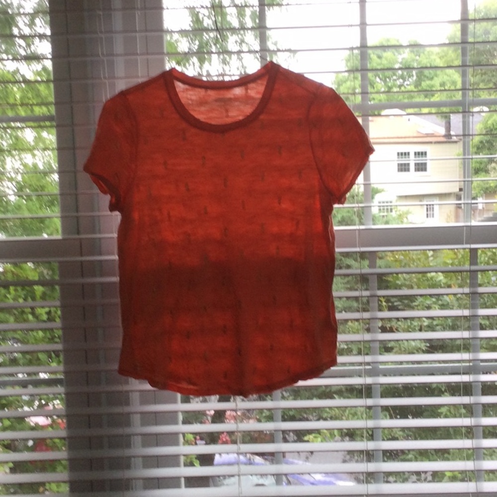 Peach t-shirt with gold foil pineapple details.